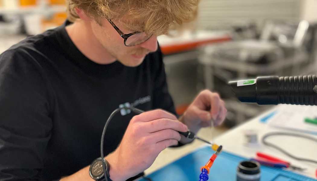 An engineer soldering a component